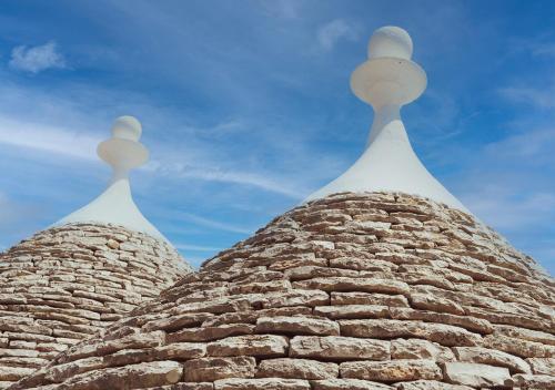 two spires of a building with the sky in the background at I trulli di Eva in Noci