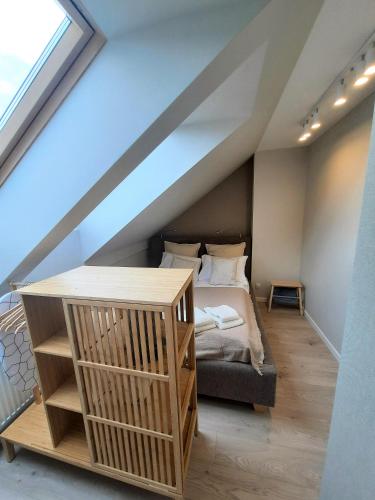 a bedroom with a bed in a attic at PLUSK Apartments Mrągowo in Mrągowo