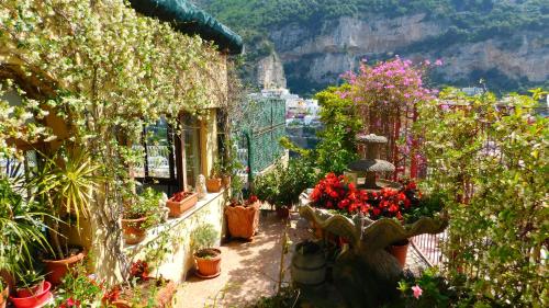 a bunch of potted plants and flowers on a building at Villaverde in Positano