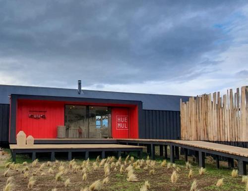 a building with a bunch of chickens in front of it at Kau Rio Serrano in Torres del Paine