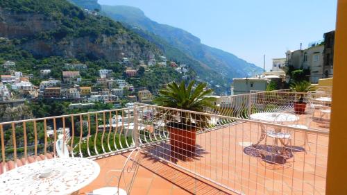 a balcony with tables and a view of a city at Villaverde in Positano