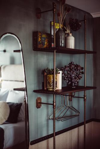 a room with a shelf next to a bed at Babel Belleville in Paris
