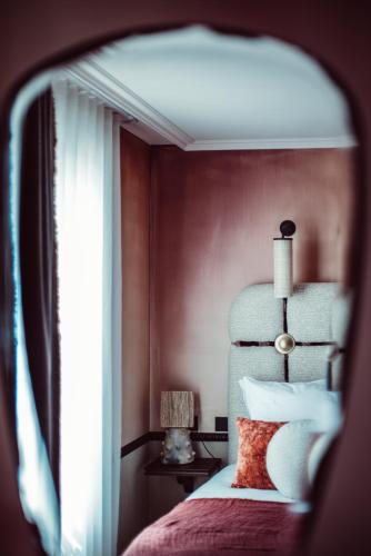 a bedroom with a bed and a window at Babel Belleville in Paris