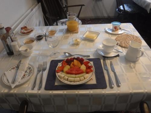 a table with a plate of fruit on a table at Morawel in Fishguard