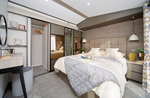 a bedroom with a large bed with a woman laying on it at 1.2 padstow in Padstow