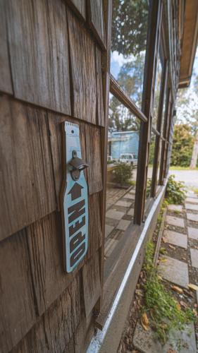 a house with a sign on the side of a building at Hostal Climb House in Puerto Varas