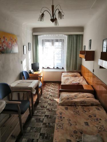 a room with four beds and a desk and a window at Apartmány v centru u Moravců in Třeboň