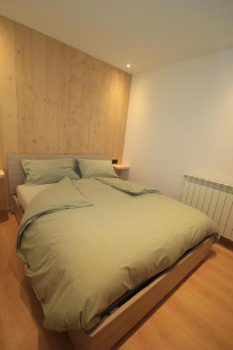 uma cama grande num quarto com em Anemone Home em Santa Caterina di Valfurva