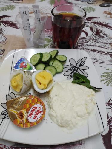a plate with eggs and vegetables and a cup of tea at Four Seasons Hotel in Hurghada