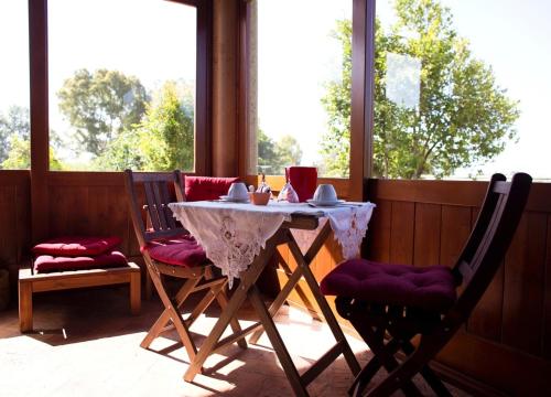 a table and two chairs in a screened in porch at Al Vecchio Fontanile B&B in Ladispoli