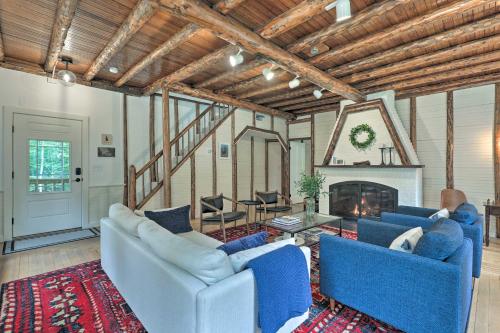 a living room with blue couches and a fireplace at Charming Jaffrey Cottage with Deck and Grill! in Jaffrey
