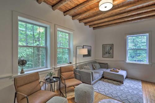 a living room with a couch and chairs and windows at Charming Jaffrey Cottage with Deck and Grill! in Jaffrey
