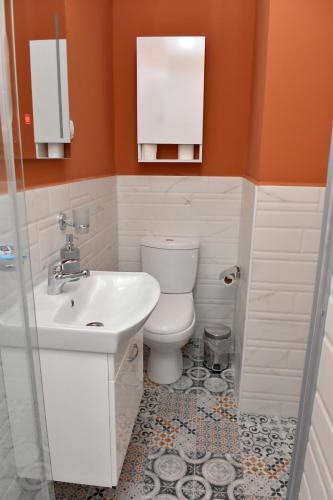 a bathroom with a toilet and a sink at Good Times Luxury Apartments Bitola in Bitola