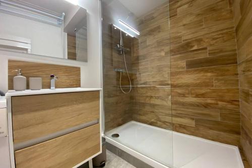 La salle de bains est pourvue d'une douche avec une porte en verre. dans l'établissement Place de Metz, Hyper-centre Grenoble, Studio 25 m2, à Grenoble