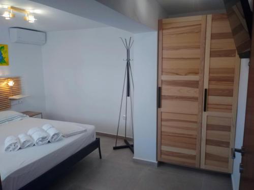 a bedroom with a bed and a tripod next to a door at Estella Studios in Elafonisos