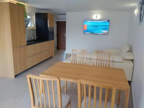 a living room with a table and chairs and a couch at Estella Studios in Elafonisos