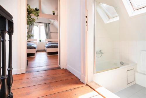 a bathroom with a shower and a bath tub at Antwerp Old Town Centrum Apartment in Antwerp