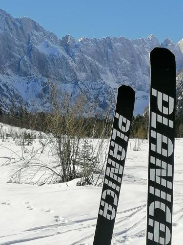 a pair of skis are standing in the snow at Žbogar in Rateče