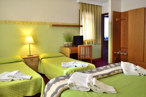 Postel nebo postele na pokoji v ubytování Hotel Vajolet