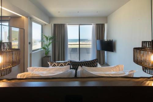 a living room with a couch and a view of the ocean at Allonda Seafront Experience in Stavros