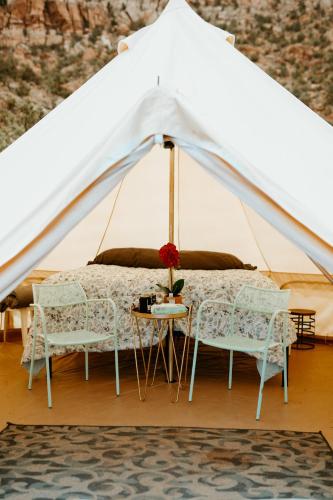 a white tent with two chairs and a bed at Zion View Camping in Hildale