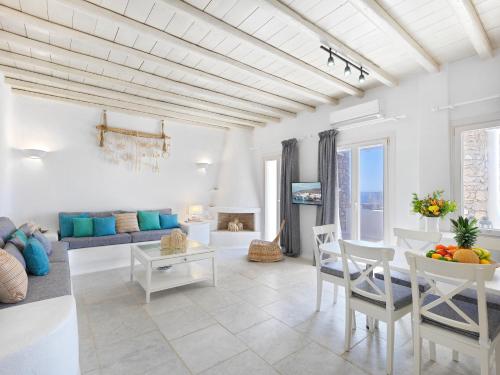 a living room with a couch and a table at Sunset Villas in Mykonos by White Hills in Mikonos