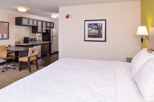 a hotel room with a bed and a kitchen at Candlewood Suites Paducah, an IHG Hotel in Paducah