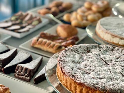 a display of different types of cakes and pastries at Hotel Continental in Tortoreto Lido