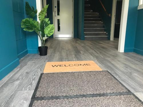 a welcome mat on the floor of a hallway at Rostrevor Mountain Lodge - Glamping Pods - Revive Sauna & Hot Tubs in Rostrevor