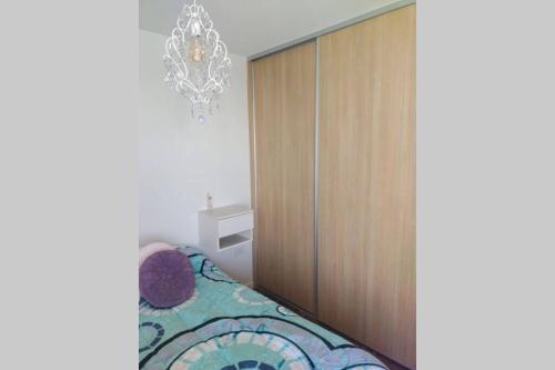 a bedroom with a large wooden cabinet and a bed at departamento céntrico relax in Rosario
