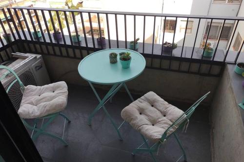 a table and two chairs on a balcony at departamento céntrico relax in Rosario