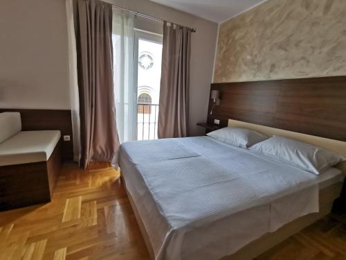 a bedroom with a large bed and a window at Villa Salvia in Mostar