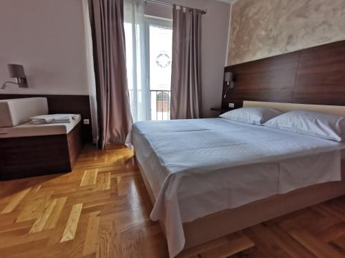 a bedroom with a large bed and a window at Villa Salvia in Mostar
