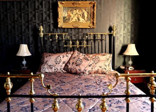 a bedroom with a bed and two lamps at Shakespeare Hotel in Sydney