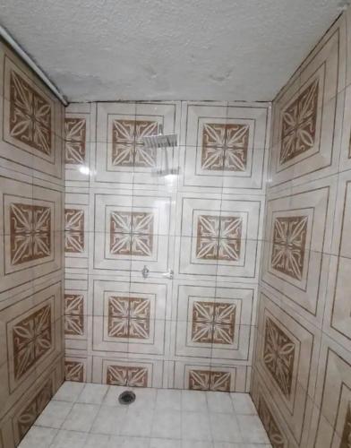 a room with a white tile wall with a ceiling at Habitación completa a 2 Cuadras del Consulado EUA in Nuevo Laredo