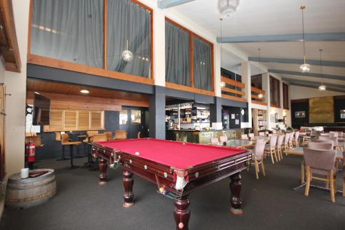 a pool table in a room with tables and chairs at Lakeside Falls Creek in Falls Creek