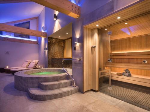 a bathroom with a jacuzzi tub with stairs at The Shippon Cottage in Kendal