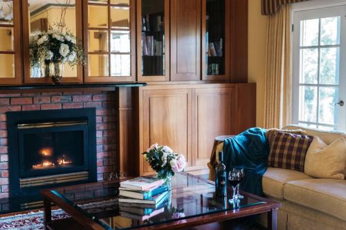 a living room with a couch and a fireplace at Lawson Lodge Country Estate in Macedon