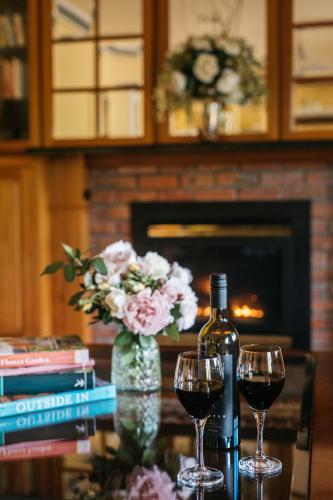 a table with two glasses of wine and a bottle at Lawson Lodge Country Estate in Macedon