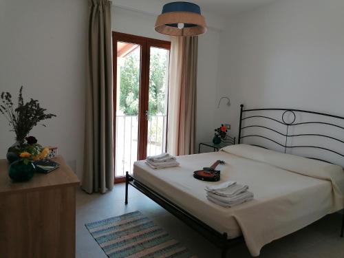 a bedroom with a bed with a telephone on it at Body and Soul in Cala Gonone