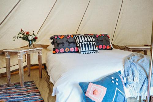 a bed in a tent with some pillows on it at Lawson Lodge Country Estate in Macedon