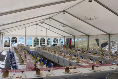 a marquee set up for a banquet with tables and chairs at Sognefjord Hotel in Hermansverk