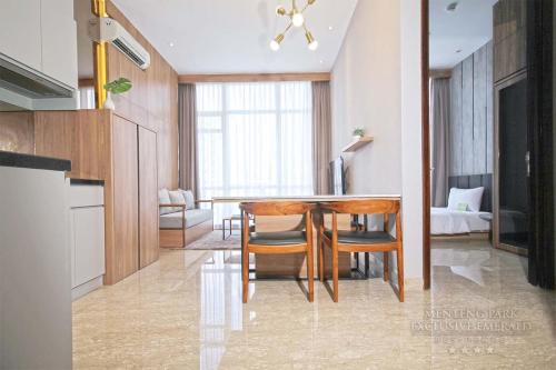 a kitchen and dining room with a table and chairs at Menteng Park Exclusive Emerald in Jakarta