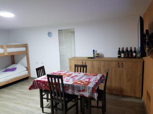 a dining room with a table with chairs and a bed at Kuca Stojanovica Topli Do in Pirot