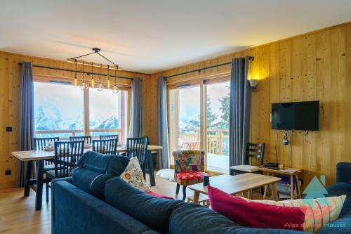 a living room with a couch and a dining room at Respire - Apt 4 Chambres 92m2, Hameau de Clotaire in LʼHuez