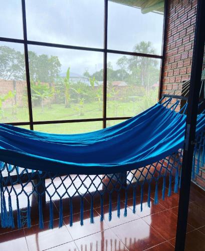 a hammock in a room with a window at Saraya Lodge & Camping in Iquitos
