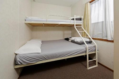 a room with two bunk beds and a window at Mudgee Valley Park in Mudgee