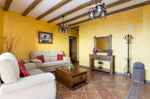 a living room with a couch and a table at Home2Book Charming Apartment Los Realejos in Los Realejos