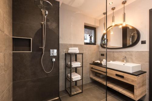 a bathroom with a sink and a shower at Seven Reasons / Panorama View in Hart im Zillertal
