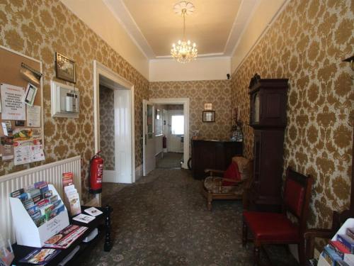 a hallway with a room with wallpaper at Spring Garden Apartments in Gosport